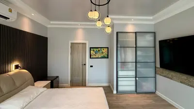 a bedroom with a bed and a flat screen tv at Villa Sofia in Ban Phak Chit