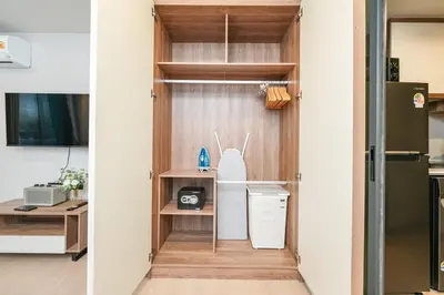 a door into a kitchen with a desk and a refrigerator at Boat Avenue Modern Loft in Ban Thalat Choeng Thale