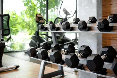 a bunch of dumbbells on display in a gym at Boat Avenue Modern Loft in Ban Thalat Choeng Thale