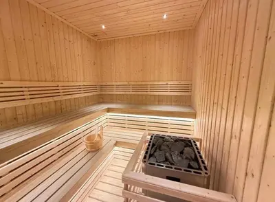 a wooden sauna with a stove in the middle at Boat Avenue Modern Loft in Ban Thalat Choeng Thale
