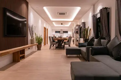 a living room with a couch and a table at Luxury 3 bed villa with private pool, Rawai Phuket in Rawai Beach