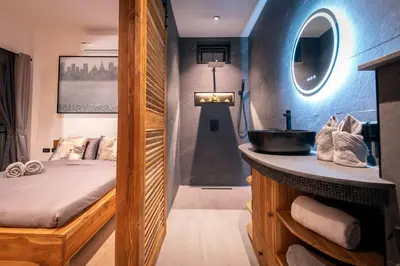 a bathroom with a sink and a bed and a mirror at Luxury 3 bed villa with private pool, Rawai Phuket in Rawai Beach