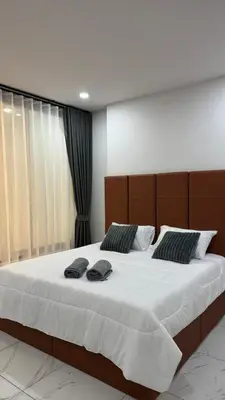 a bedroom with a large bed with two hats on it at Bang Jo Garden Home in Koh Lone