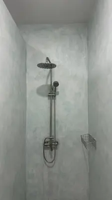 a shower with an umbrella on the wall at Bang Jo Garden Home in Koh Lone