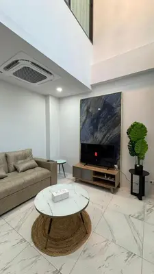 a living room with a couch and a coffee table at Bang Jo Garden Home in Koh Lone