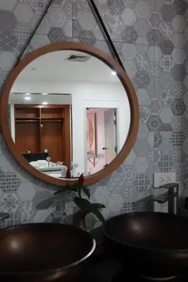 a mirror in a bathroom with a sink at Baan Chang Sanctuary in Laguna Phuket