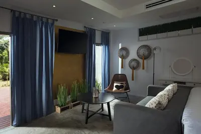 a living room with a couch and a table at Baan Chang Sanctuary in Laguna Phuket