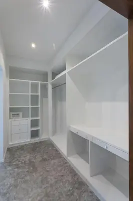an empty closet with white walls and white shelves at Baan Chang Sanctuary in Laguna Phuket