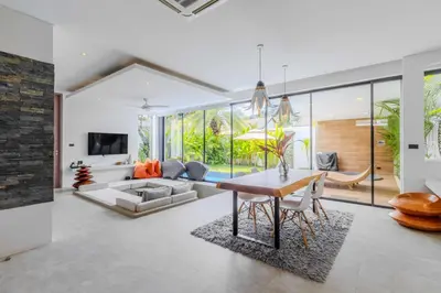 a living room with a table and a couch at V259 Great for Relaxing with Pool & Full Amenities in Thalang