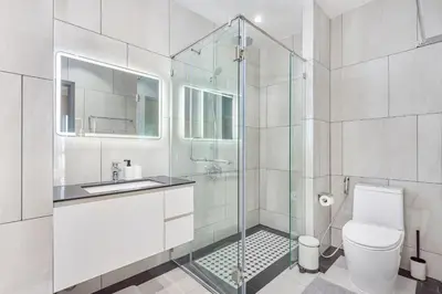 a bathroom with a shower and a toilet and a sink at Title Legendary Bang Tao by My Home Phuket in Ban Nong Chaeng