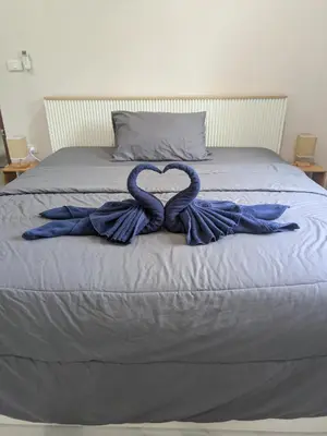 a bed with two ribbons in the shape of a heart at Samakki Residence - Modern Rooms, Quiet Area, Near the Beach in Rawai Beach