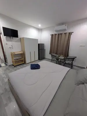 a large bed in a room with a flat screen tv at Samakki Residence - Modern Rooms, Quiet Area, Near the Beach in Rawai Beach