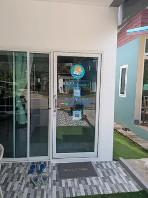 a pair of shoes sitting outside of a store door at Samakki Residence - Modern Rooms, Quiet Area, Near the Beach in Rawai Beach