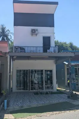 a building with a balcony with tables and chairs at Samakki Residence - Modern Rooms, Quiet Area, Near the Beach in Rawai Beach