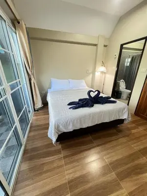 a bedroom with a bed with a robe on it at Samakki Residence - Modern Rooms, Quiet Area, Near the Beach in Rawai Beach