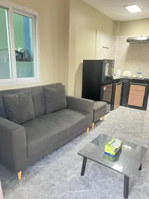 a living room with a couch and a coffee table at Samakki Residence - Modern Rooms, Quiet Area, Near the Beach in Rawai Beach