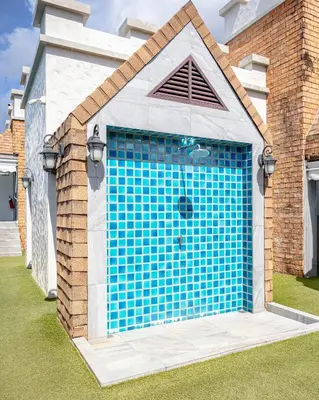 a garage with a blue door in a house at Cozy studio Pool View near of NaiYang beach in Nai Yang Beach