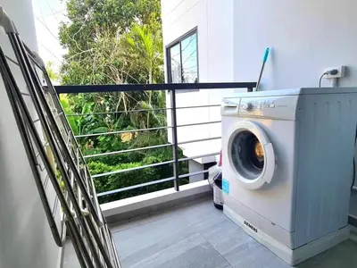 a washing machine in a room with a window at Modern 61m² Apt - Central Chalong/ Fast WiFi in Ban Thalat Choeng Thale