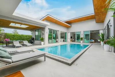 a swimming pool in the backyard of a house at Villa Mimosa 4 - Luxury 4BR Private Pool - Rawai in Kata Beach
