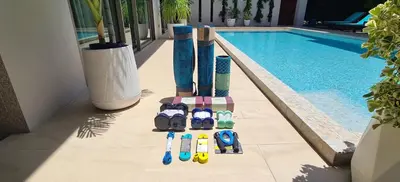 a group of bowling pins next to a swimming pool at Villa Mimosa 4 - Luxury 4BR Private Pool - Rawai in Kata Beach