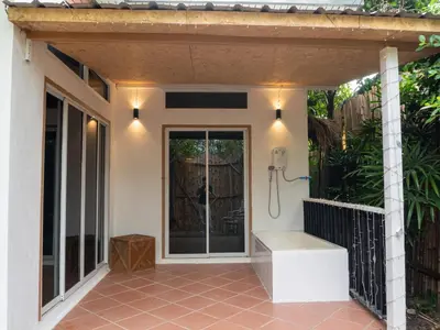a patio with a shower and a bench on a house at The Fifth Bamboo in Laguna Phuket