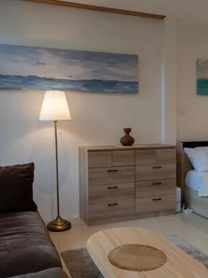 a living room with a bed and a dresser at The Fifth Bamboo in Laguna Phuket