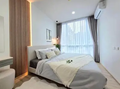 a bedroom with a bed and a large window at The Modern central Phuket base condo by luxStays in Ban Rangeng