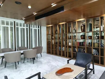 a room with a table and chairs and shelves with vases at The Modern central Phuket base condo by luxStays in Ban Rangeng