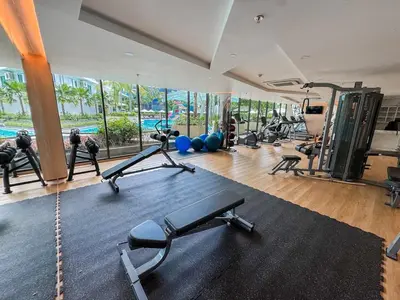a gym with treadmills and exercise equipment in a building at Cozy 1Bdr Apartment in La Vita Rawai Nai Harn in Rawai Beach