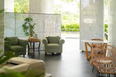 a living room with chairs and a table at Cozy 1Bdr Apartment in La Vita Rawai Nai Harn in Rawai Beach