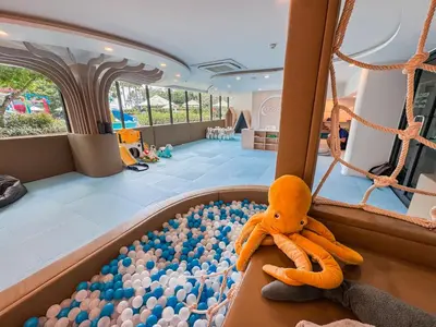 a toy squid sitting in a pool of balls at Cozy 1Bdr Apartment in La Vita Rawai Nai Harn in Rawai Beach