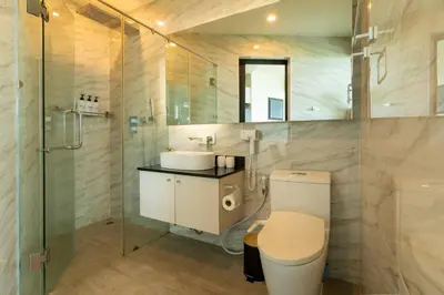 a bathroom with a toilet and a shower and a sink at Modern condo with full sea view, 4 min walk to Kamala beach in Kamala Beach