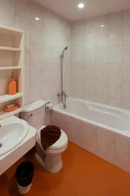 a bathroom with a toilet and a tub and a sink at Nova Patong in Patong Beach