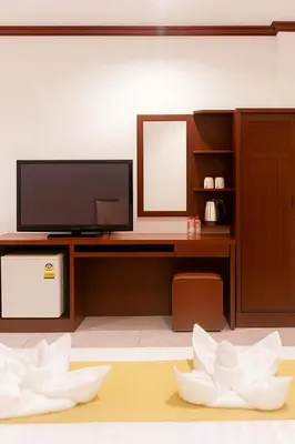 a living room with a desk with a tv and a mirror at Nova Patong in Patong Beach