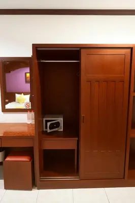a closet with a door and a tv in a room at Nova Patong in Patong Beach