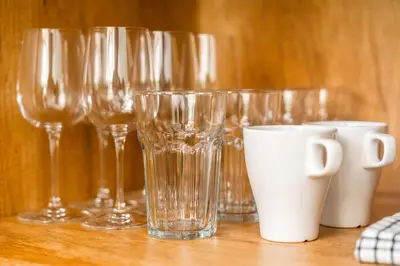 a group of glasses sitting on a wooden table at Tropical Holiday Retreat 1BR Villa Near Bangtao in Ban Pak Lak