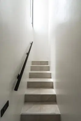 a staircase with white walls and a stair case at Tropical Holiday Retreat 1BR Villa Near Bangtao in Ban Pak Lak