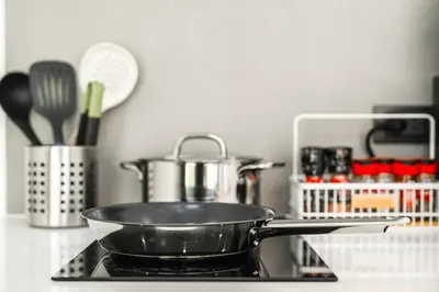 a pan sitting on top of a stove in a kitchen at Tropical Holiday Retreat 1BR Villa Near Bangtao in Ban Pak Lak