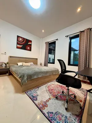 a bedroom with a bed and a desk and a chair at Cozy family cottage w pool Bang Tao in Phuket