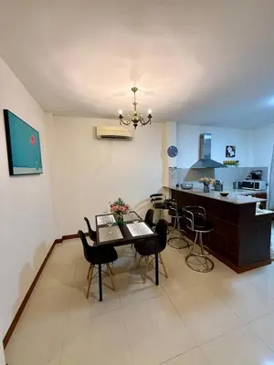 a dining room and kitchen with a table and chairs at Cozy family cottage w pool Bang Tao in Phuket