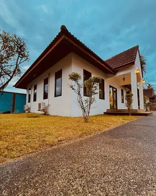 a house with a grass yard in front of it at Cozy family cottage w pool Bang Tao in Phuket