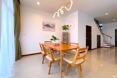 a dining room with a wooden table and chairs at Goldena Twin Private Villas - Duplex Villa with Sauna, Kamala in Kamala Beach