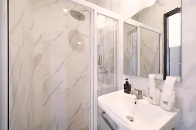 a white bathroom with a sink and a shower at Goldena Twin Private Villas - Duplex Villa with Sauna, Kamala in Kamala Beach