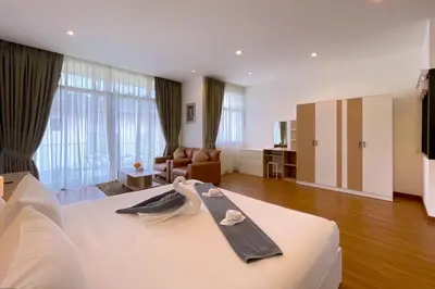 a hotel room with a bed with a robe on it at Goldena Twin Private Villas - Duplex Villa with Sauna, Kamala in Kamala Beach