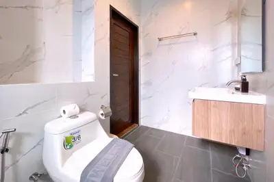 a bathroom with a white toilet and a sink at Goldena Twin Private Villas - Duplex Villa with Sauna, Kamala in Kamala Beach