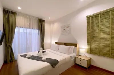 a bedroom with a large white bed and a window at Goldena Twin Private Villas - Duplex Villa with Sauna, Kamala in Kamala Beach