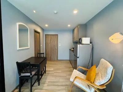 a kitchen and dining room with a table and a refrigerator at Comfy studio - 10 min walk to NaiYang Beach in Nai Yang Beach