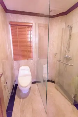 a bathroom with a toilet and a glass shower at Classic Cozy Thai Villa BIG pool Party OK in Patong Beach