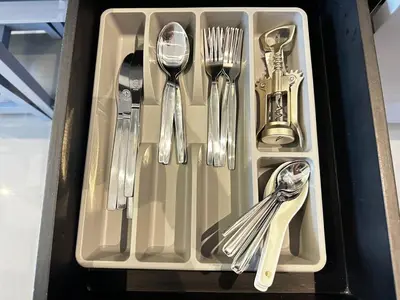 a tray with silver utensils and forks and spoons at Citygate Apartament in Kamala Beach