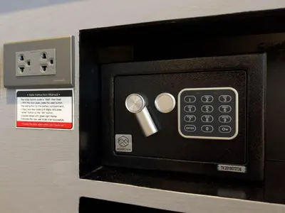 a microwave with a remote control in a box at Citygate Apartament in Kamala Beach